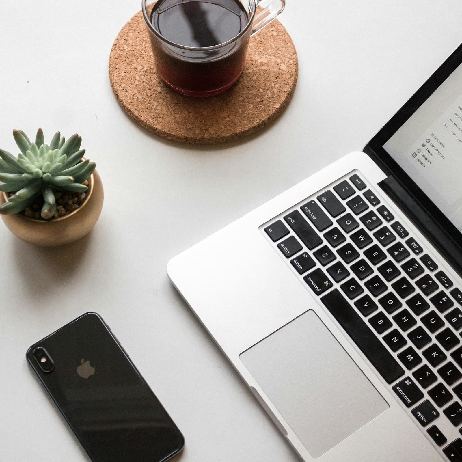 Flat lay of notebooks, brand assets and design tools gathered before a Cochrane website build